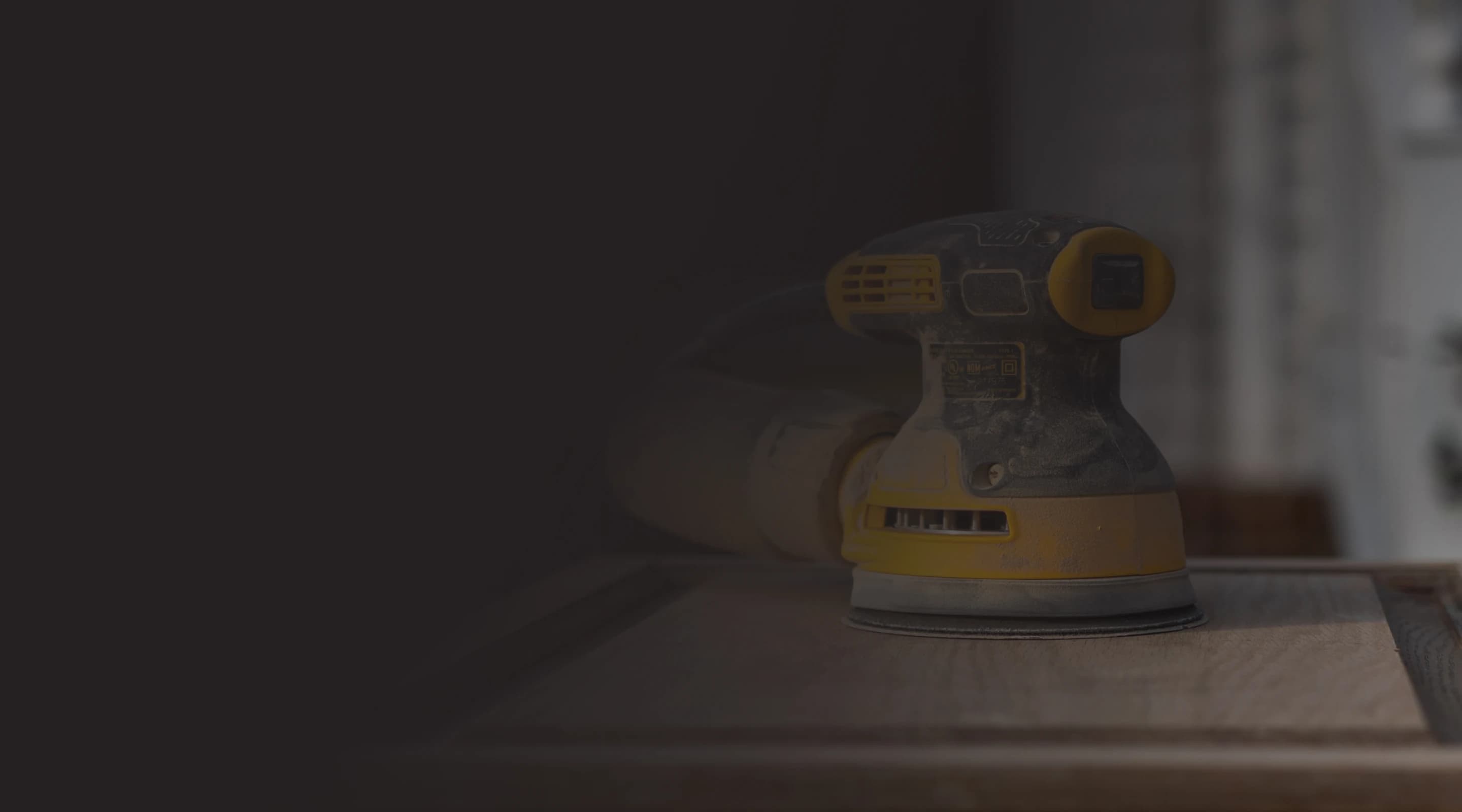 Person woodworking with power tools.